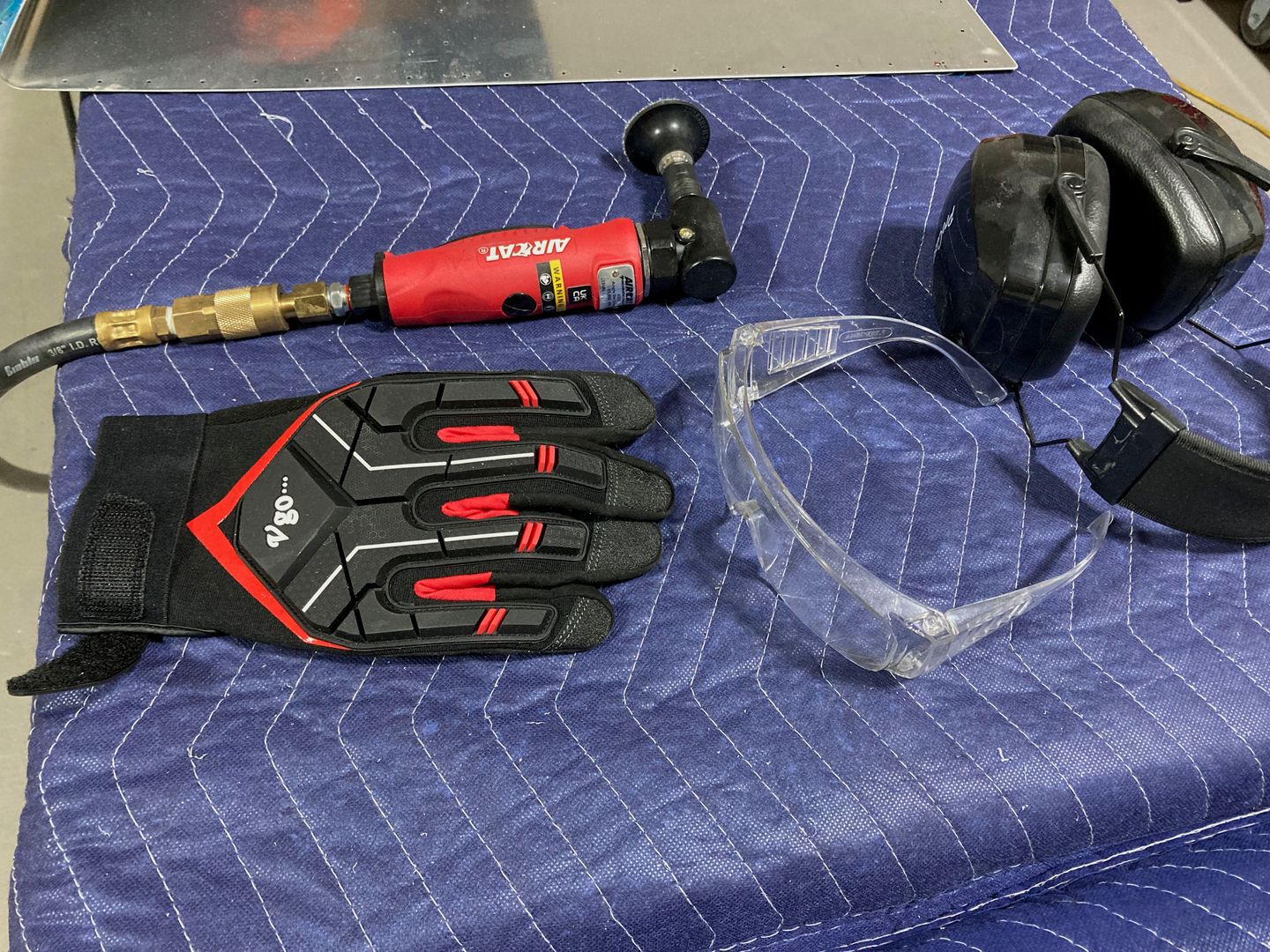 Aircat die grinder with a roloc attachment and blue Scotch-Brite disc.