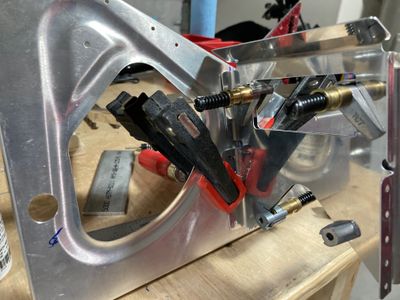 Clamping the crotch strap to the rib.