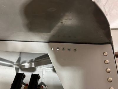 Removing the rivets.