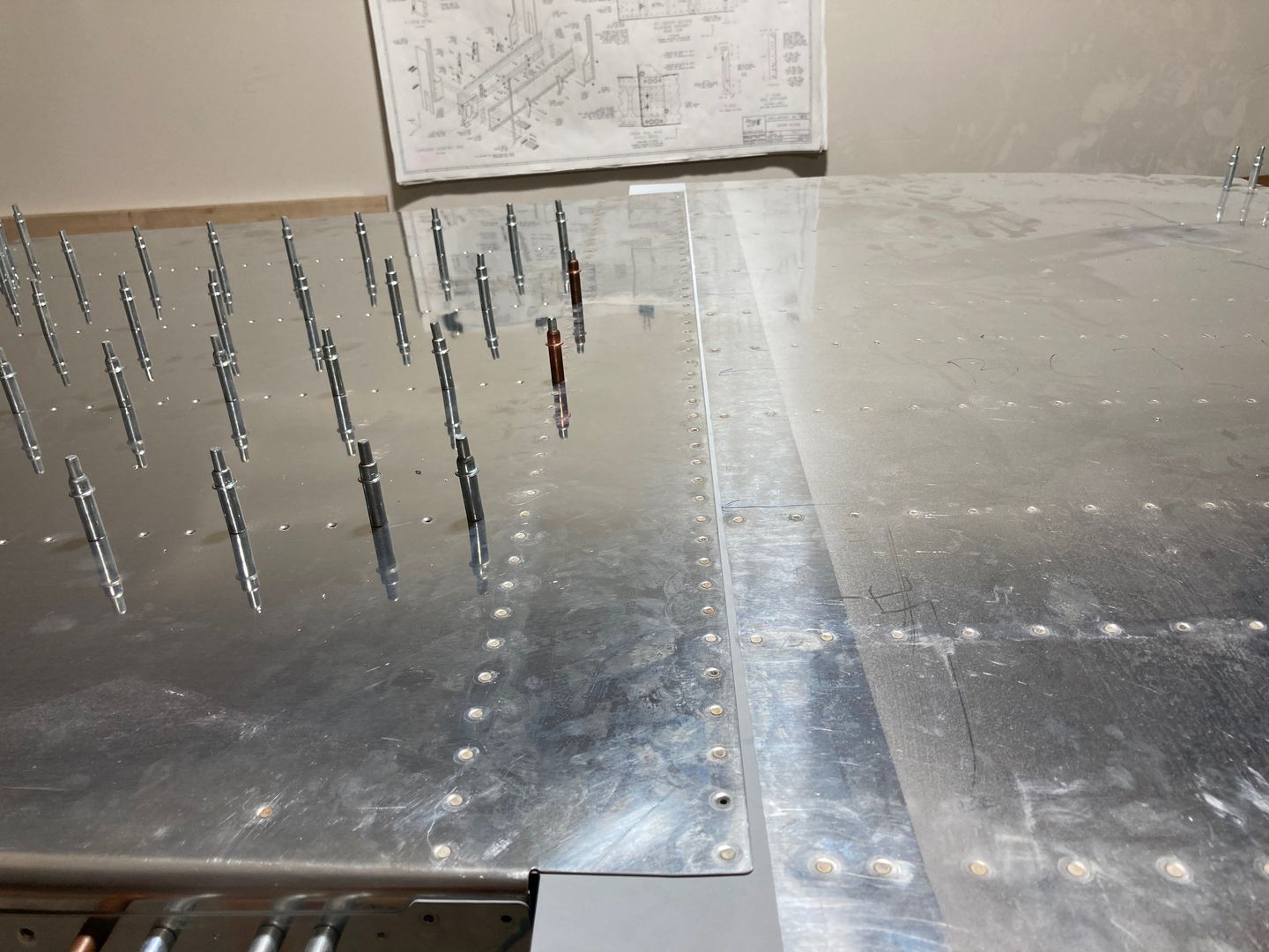 The F-704 is riveted to the bottom skins.