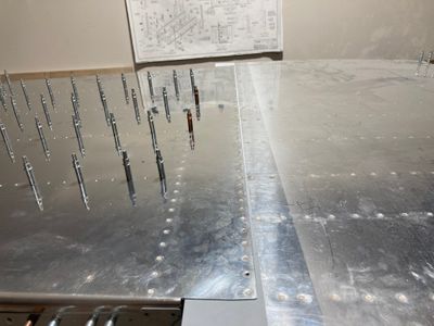 The F-704 is riveted to the bottom skins.