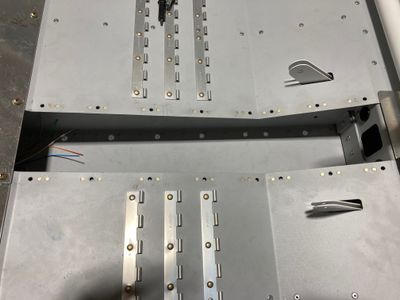 The nutplates are installed in the central tunnel.