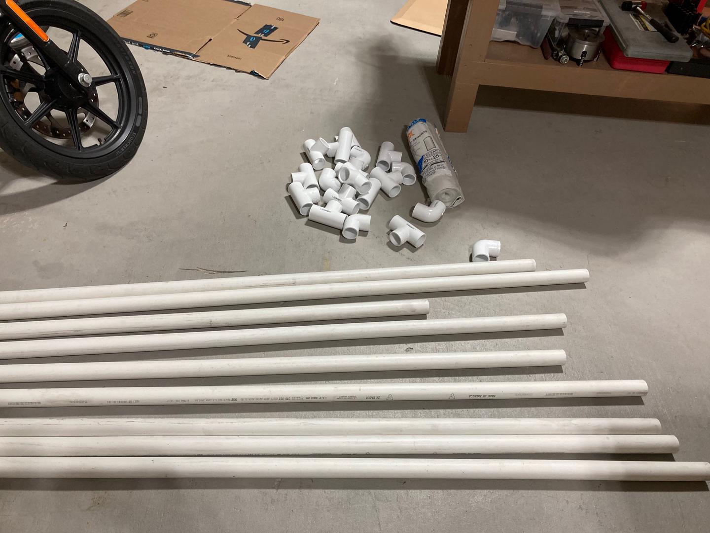 Parts for the paint booth: 9 1-1/4" PVC pipes, 6 right angles and 13 tees.