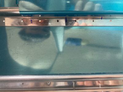 Marking the location of the bracket holes.