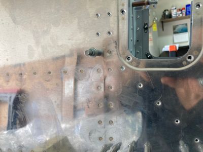 Dent in the fuselage skin.