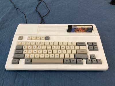 Clone of a MSX computer with a game cartridge inserted.
