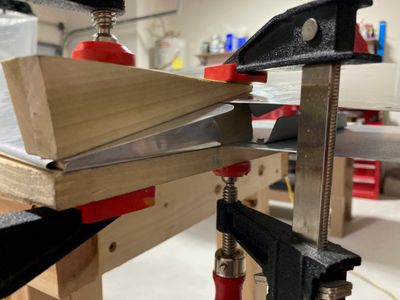 The process of bending the tabs.