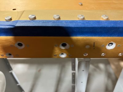 The rivets hidden by the fuel tank skins.