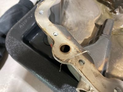 Piece of PTFE tape pulled from the external threads.