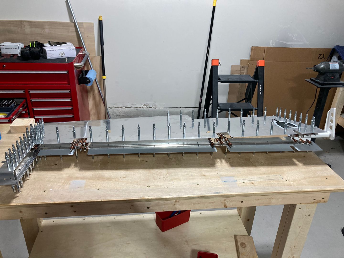 The elevator temporarily clecoed for the drilling operation.