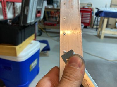Using a chisel to cut off bumps.