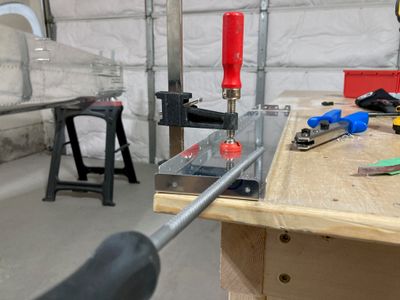 Filing the hole for the snap bushing.