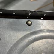 The rivet covering the tooling hole.