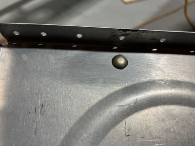 The rivet covering the tooling hole.