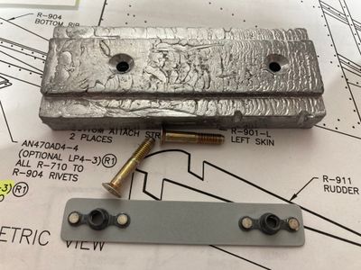 The counterweight and its retaining plate.