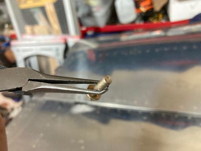 The modified pliers to hold the bolts.